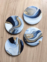Load image into Gallery viewer, Blue, gold and white marbled coasters
